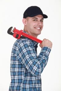 Alameda plumbing team member poses with a pipe wrench